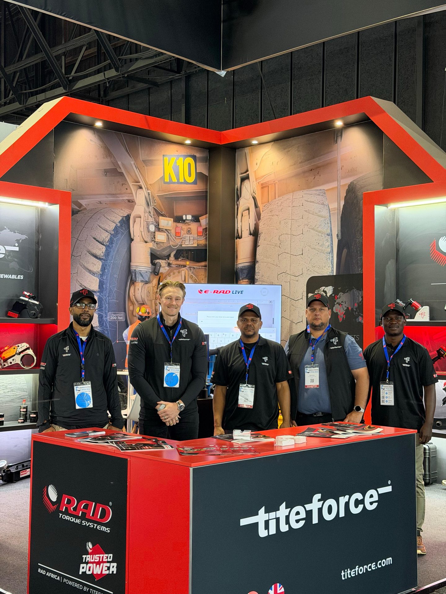Titeforce team members at the front counter of stand K10