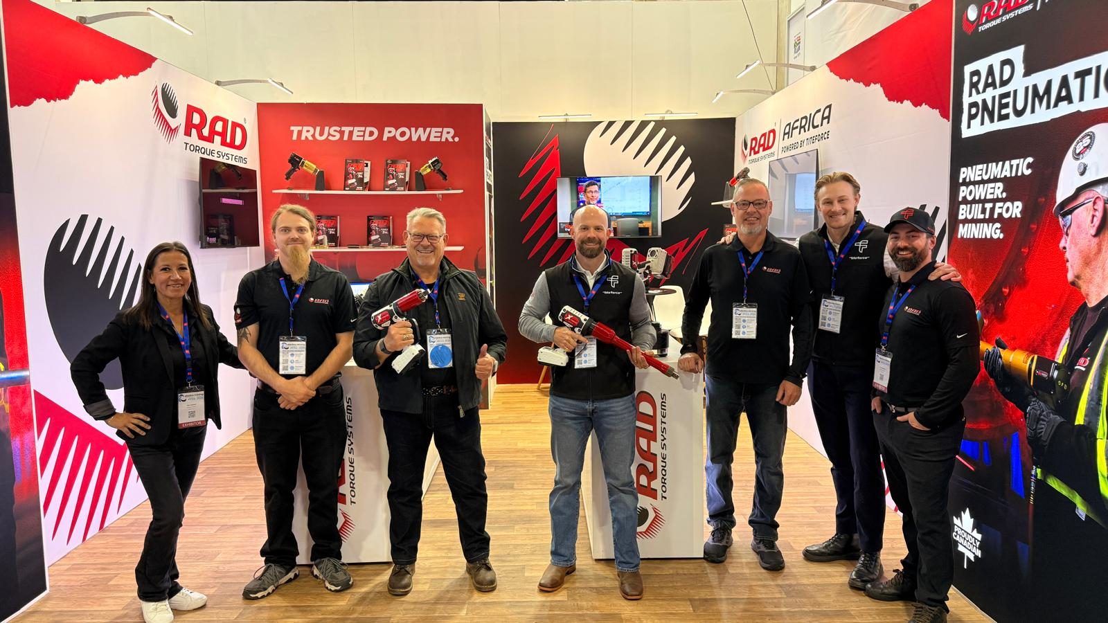 RAD Torque Systems and Titeforce staff holding B-RAD tools on the RAD stand