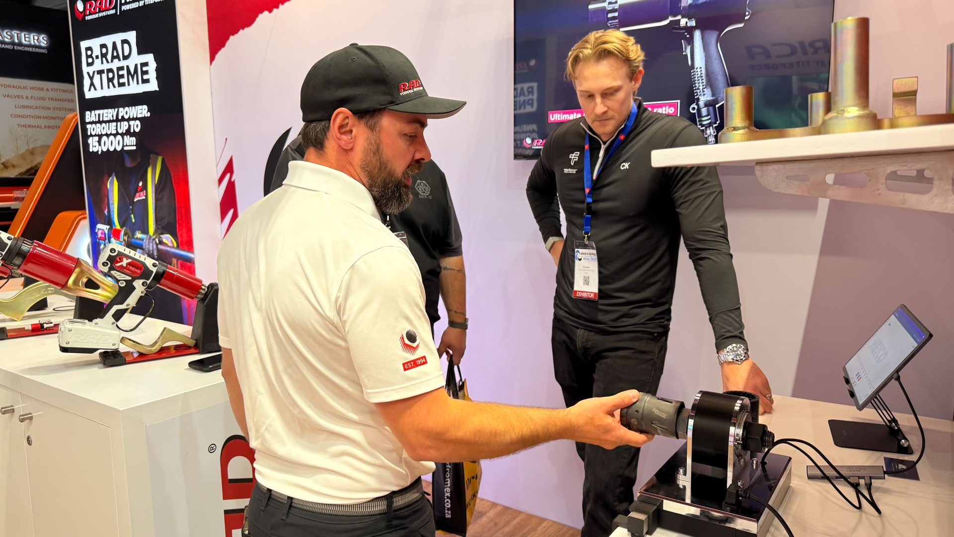 RAD team member demonstrating the torque test bench to a visitor