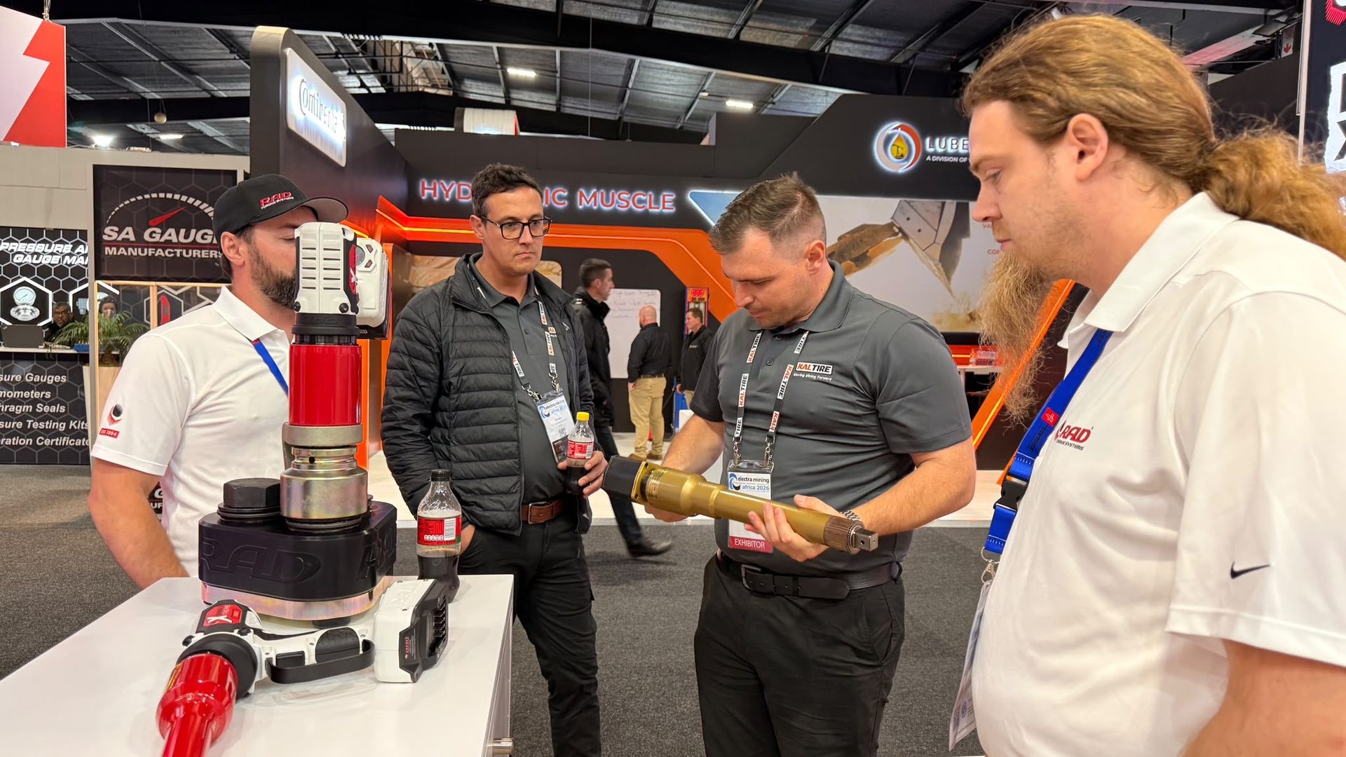Visitors from Kal Tire inspecting a RAD pneumatic torque tool with the RAD team