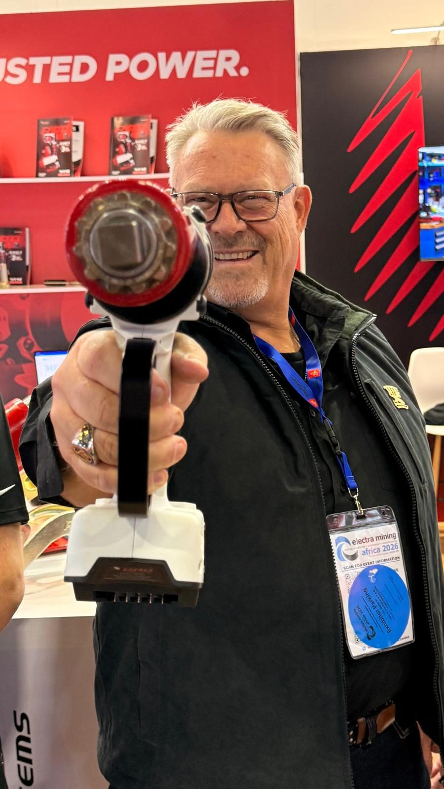 B-RAD Xtreme torque tool held up in front of the Trusted Power wall